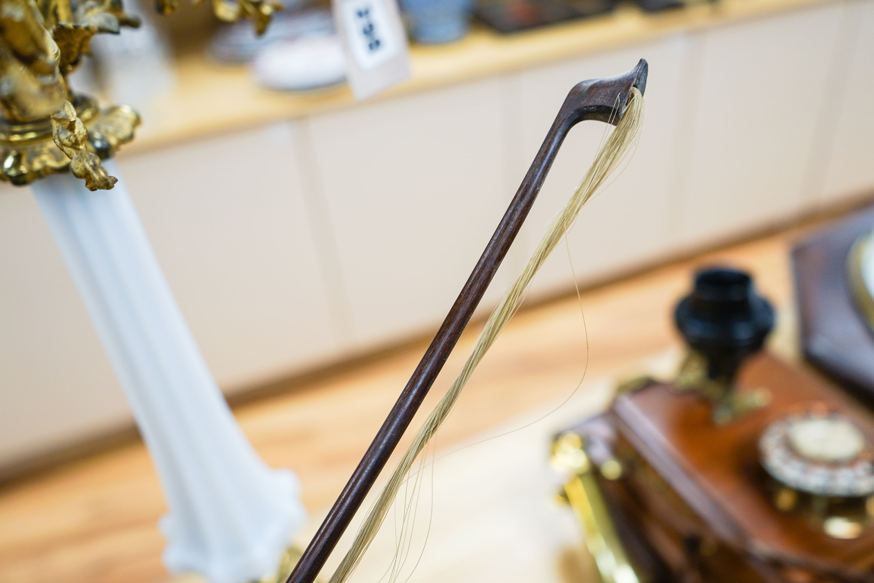A violin labelled Francesco Ruggeri and a bow. Back of violin excluding button - 36cm